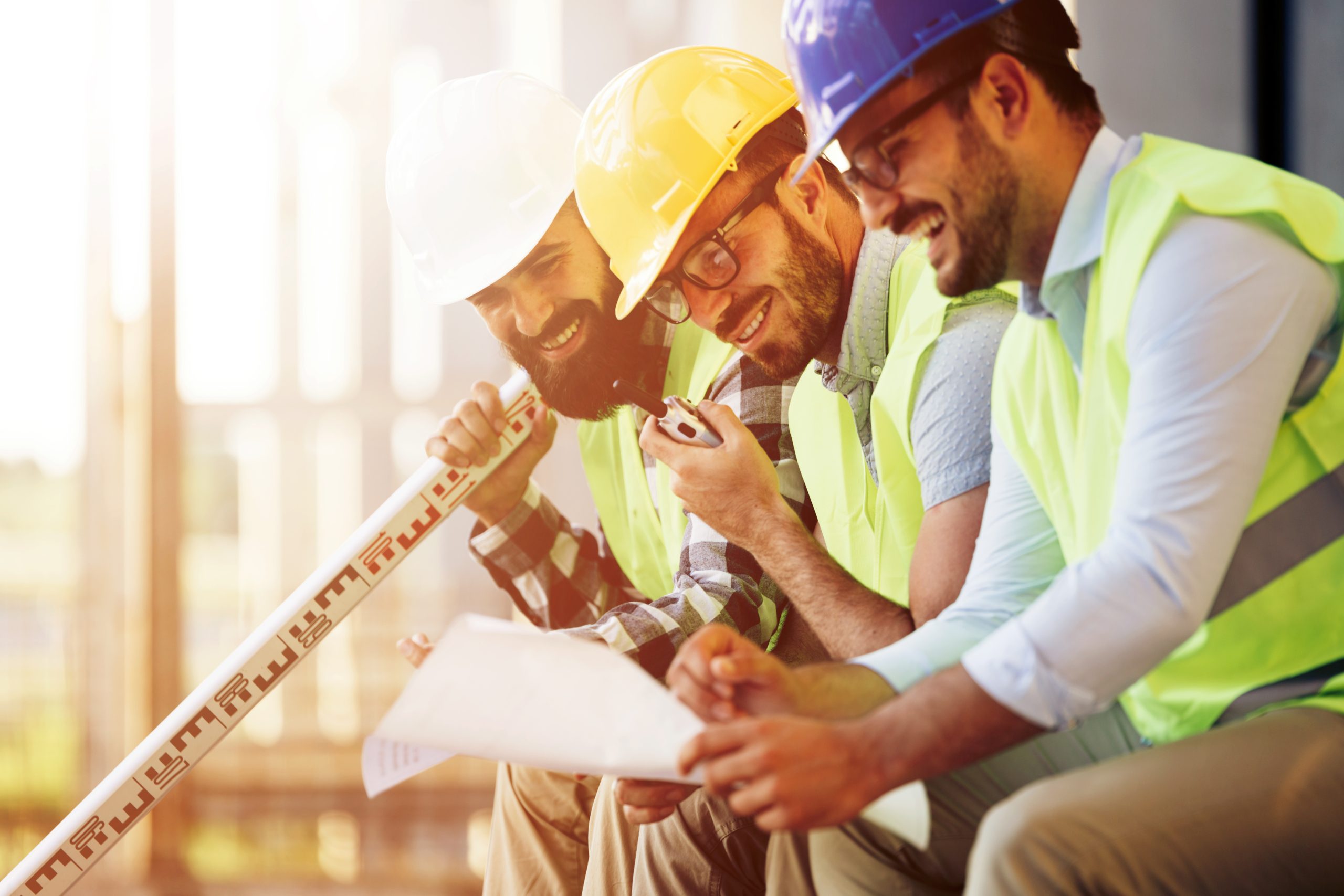 Portrait of construction engineers working on building site together